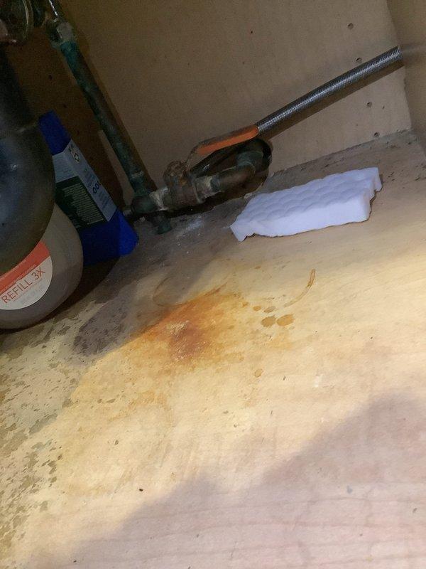 Responded to outdoor faucet leak on white vinyl siding. Upon inspection, found brass hose bib with significant water staining and discoloration around pipe penetration point, indicating active leak at wall connection. Documented existing damage to siding from prolonged water exposure. Assessed fixture condition and determined replacement necessary due to failed seal at mounting point. Photographed evidence of leak damage for customer review and estimate preparation.