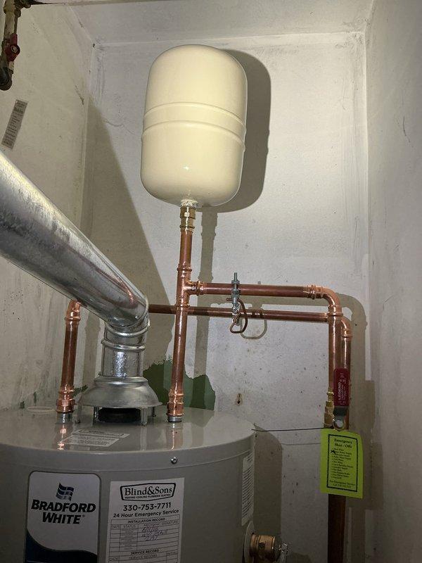 Replaced a failed 40-gallon tall gas water heater originally installed in 2010. The existing unit had a non-functioning pilot light due to a faulty gas control valve and pilot assembly. After evaluating repair versus replacement options, determined that replacement was the most cost-effective solution given the unit's age and expired warranty.

Removed the old water heater and installed a new Bradford White 40-gallon tall residential gas water heater with a 6-year manufacturer warranty. Performed all necessary code upgrades including installation of a new gas cock, expansion tank, and ball valve. Connected copper supply lines with soldered joints in proper configuration. Mounted expansion tank on wall above the water heater with appropriate piping connections. Installed flexible gas connector and verified all gas connections for proper operation and safety. Connected vent pipe to ensure proper exhaust ventilation from the unit.

Tested the new water heater for proper ignition, burner o