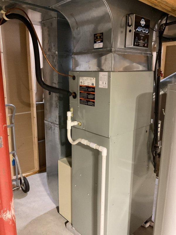 Completed comprehensive air conditioning tune-up on residential HVAC system, including thorough inspection of evaporator coil assembly which showed clean aluminum fins in good condition with intact honeycomb pattern and proper airflow clearance. Inspected air handler unit, verified proper operation of condensate drainage system, checked electrical connections and controls including wall-mounted APCO air purification system, and provided complimentary carbon monoxide detector for customer safety.