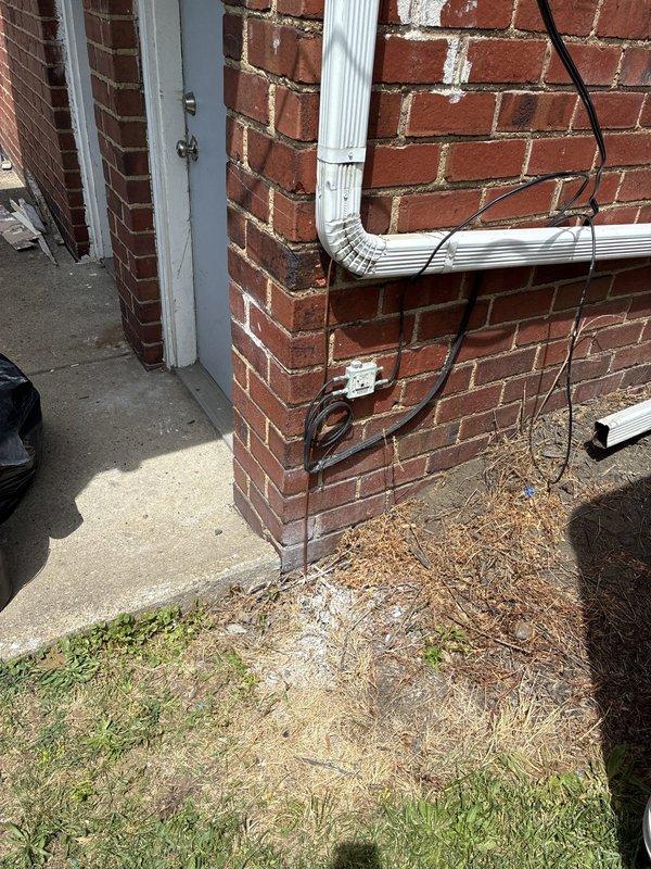Completed electrical service upgrades to meet code requirements for re-energization. Installed two new ground rods for proper service grounding, with grounding electrode conductors routed along exterior building wall. Established bonding connections for water service line and bonded hot water, cold water, and gas piping systems per NEC requirements. Installed two new dedicated circuits for electric water heater installations—first circuit terminated near main panel location, second circuit extended across basement to exterior wall with exterior-rated disconnect and flexible conduit whip connection to water heater unit.