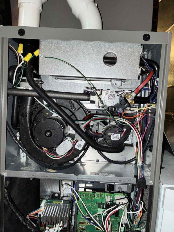 # HVAC Maintenance - Cooling

Performed comprehensive spring preventive maintenance on Lennox air conditioning system less than one year old. Inspected outdoor condenser unit positioned on rubber isolation pad, verified proper installation and clearances from structure. Checked electrical disconnect, refrigerant line connections, and condenser coil condition. Accessed indoor air handler, inspected blower motor assembly, verified all electrical connections and wire terminations secure. Examined control board operation, checked condensate drain system with visible PVC discharge piping, and confirmed all safety controls functioning properly. System operating within manufacturer specifications with no deficiencies noted.