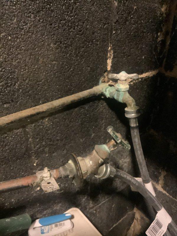 Responded to service call for burst 10-year-old pipe underneath bathroom sink. Upon arrival, confirmed water was already shut off at fixture shutoff valve to prevent further damage. Replaced deteriorated copper piping and corroded brass fittings showing significant verdigris buildup beneath sink. Installed new internal toilet tank components as requested. Assessed existing washer hookup plumbing at utility sink and provided estimate for new faucet installation to accommodate laundry connection requirements.