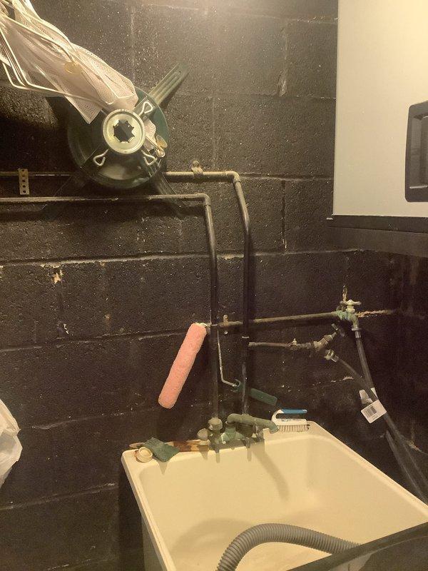 Responded to service call for burst 10-year-old pipe underneath bathroom sink. Upon arrival, confirmed water was already shut off at fixture shutoff valve to prevent further damage. Replaced deteriorated copper piping and corroded brass fittings showing significant verdigris buildup beneath sink. Installed new internal toilet tank components as requested. Assessed existing washer hookup plumbing at utility sink and provided estimate for new faucet installation to accommodate laundry connection requirements.
