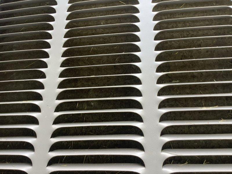 Responded to service call for central air conditioning system experiencing intermittent cooling and insufficient airflow from supply vents. Upon arrival, inspected outdoor condensing unit which showed signs of age with algae growth and surface deterioration on cabinet exterior. Evaluated indoor air distribution system and found supply register with accumulated dust and debris on louvers affecting airflow delivery. System was operational during inspection but exhibited reduced cooling capacity. Assessed unit performance and airflow characteristics to diagnose intermittent operation concerns reported over previous days.