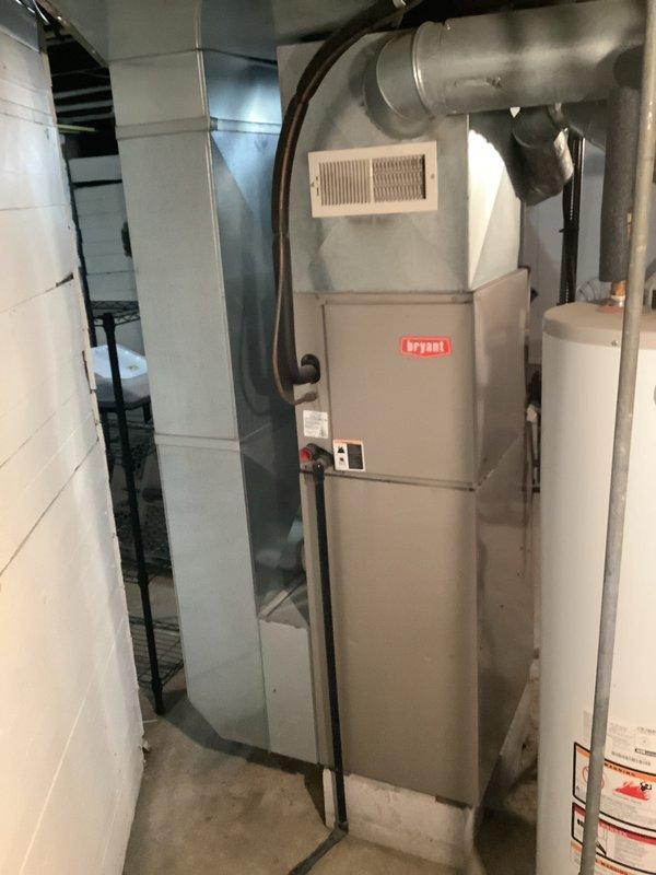 Completed full HVAC system installation including 80% efficiency furnace, air conditioning condenser unit, and hot water heater. The Bryant furnace was installed in the basement utility room with proper venting and ductwork connections, while the outdoor condenser unit was positioned on a concrete pad against the building exterior with appropriate electrical connections and conduit routing. All equipment was tested for proper operation, refrigerant lines were charged and sealed, and the system was commissioned to ensure optimal performance and efficiency.