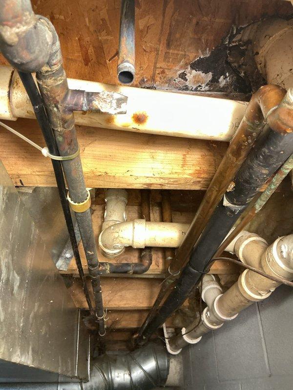 Responded to a water leak in the basement involving a copper water line serving the reverse osmosis system. Upon inspection, identified a hole in the copper line that was causing active water leakage. The damage appeared to have been caused by previous work or interference from another party. Completed necessary repairs to the compromised copper line, restoring proper water supply to the RO system and eliminating the leak. Documented existing plumbing infrastructure and repair work with photographs showing the basement plumbing configuration, including various supply and drain lines, pipe connections, and the affected copper line area.