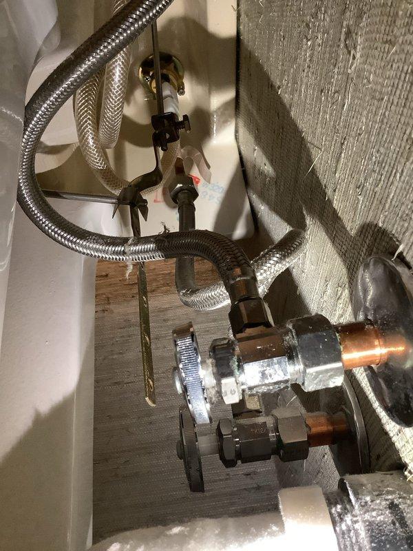 Responded to service call for leaking faucet in downstairs bathroom. Upon arrival, inspected single-handle bathroom faucet with brushed nickel finish mounted on white porcelain sink. Identified leak source and accessed supply line connections beneath sink. Replaced worn flex supply lines with new braided stainless steel hoses, installed new shut-off valves, and tightened all compression fittings to manufacturer specifications. Tested system for proper operation and verified no active leaks present upon completion.
