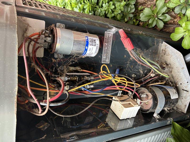 Responded to call for 14-year-old air conditioning system leaking water inside home beneath furnace. Upon inspection, identified condensate drainage issue affecting evaporator coil assembly. Examined evaporator coil fins and found unit operational but experiencing moisture accumulation due to drain line obstruction or improper drainage. Inspected outdoor condensing unit components including compressor motor, capacitor, and electrical connections. Documented condition of both indoor and outdoor equipment with photographs showing normal wear consistent with system age. Cleared debris from outdoor unit and verified all electrical connections secure.