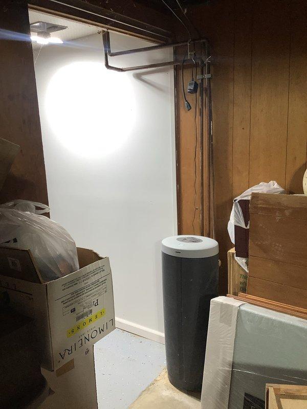 Responded to service call for whole house water filtration system requiring piping reconnection. Upon arrival, assessed the water treatment equipment located in basement utility area alongside existing water heater and water softener unit. Successfully reconnected the plumbing lines to integrate the whole house water filter back into the main water supply system, restoring proper filtration functionality to the residence.