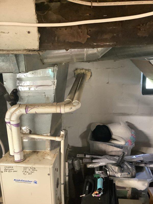 Conducted on-site assessment for furnace and air conditioning replacement estimate. Evaluated existing Robinsair furnace system in basement utility area, documented current equipment configuration including ductwork layout, condensate drainage system with PVC piping, and electrical connections. Photographed equipment specifications, mechanical room conditions, and existing HVAC infrastructure to provide comprehensive replacement proposal for both heating and cooling systems.