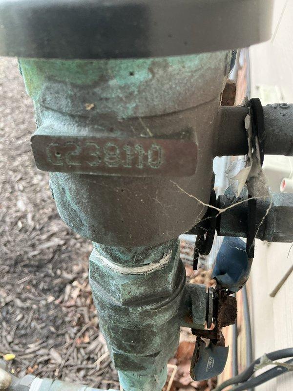 Completed annual backflow prevention device testing on residential property approximately 20-21 years old. Inspected and tested FEBCO backflow preventer assembly showing age-appropriate weathering with green patina on brass components. Device maintains proper functionality with no reported issues or symptoms prior to service. All test ports, check valves, and relief valve inspected and found operational. Pressure differential measurements recorded and verified within acceptable parameters. Device passed testing requirements and remains in service.