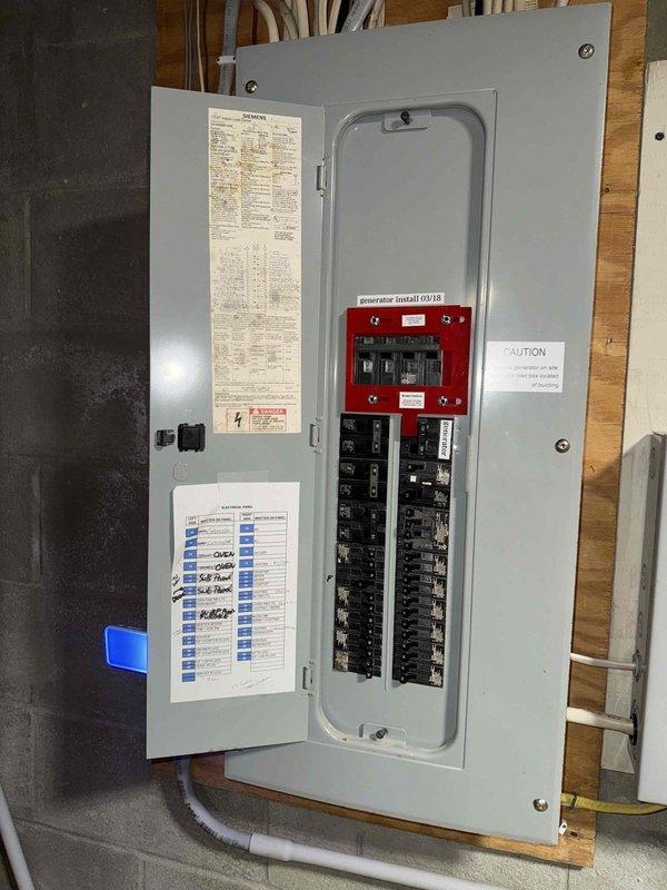 Responded to no-heat call affecting HVAC system operation. Upon inspection, discovered severe corrosion and electrical damage to furnace control sensor component, with visible burnt residue and oxidation on terminals. Removed and documented damaged blue-cased control device showing significant deterioration in central cavity. Inspected electrical panel and circuit breakers to verify proper power supply and safety interlock systems. System inoperable due to failed control component requiring replacement.