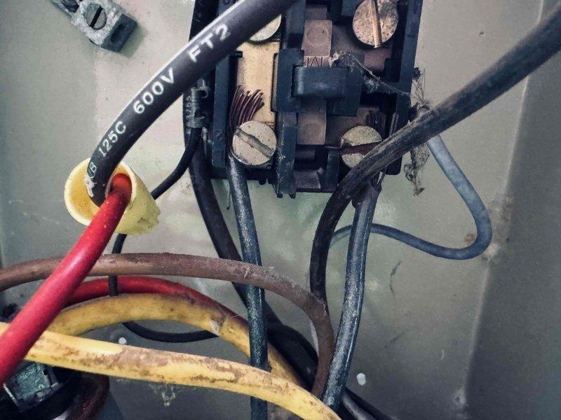 Responded to no-cool call on 15-year-old air conditioning system with outdoor unit not operating. Upon inspection, discovered failed electrical connections at the condenser unit with visible signs of age, oxidation, and deteriorated wire insulation on the 600V rated conductors at the terminal block. Outdoor unit was completely inoperative due to compromised electrical connections preventing power delivery to the compressor and condenser fan motor.