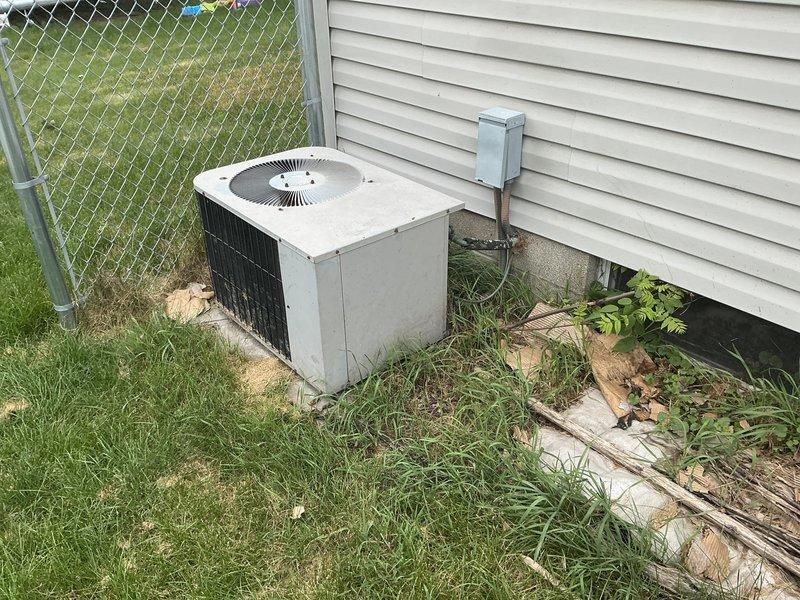 Conducted on-site evaluation of existing residential air conditioning system for replacement estimate. Documented current outdoor condenser unit condition, including weathered exterior surfaces, proper positioning on concrete pad, and electrical disconnect configuration. Generated multiple quote options for system replacement based on equipment assessment and site conditions.