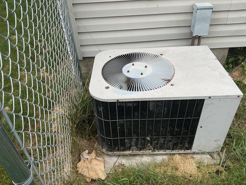 Conducted on-site evaluation of existing residential air conditioning system for replacement estimate. Documented current outdoor condenser unit condition, including weathered exterior surfaces, proper positioning on concrete pad, and electrical disconnect configuration. Generated multiple quote options for system replacement based on equipment assessment and site conditions.