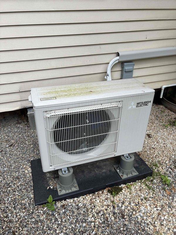 Completed preventive maintenance service on two cooling systems: a 6-year-old heat pump and a 3-year-old Mitsubishi Electric mini-split system. Inspected outdoor condenser units, verified proper operation of both systems, and replaced heavily soiled air filter which showed significant dust and debris accumulation. Both units operating within normal parameters following maintenance completion.