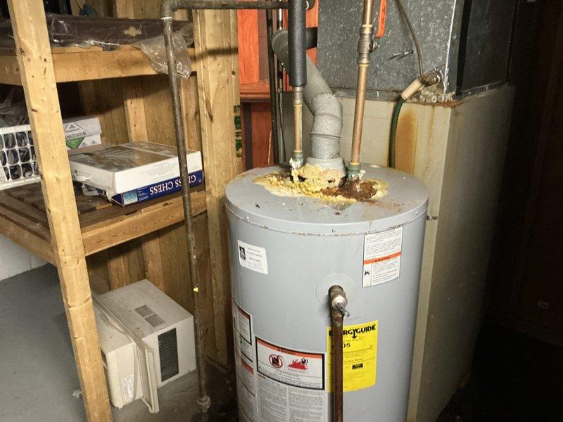 Completed comprehensive estimate for replacement of residential furnace and air conditioning system. Evaluated existing gray furnace unit installed in utility closet with horizontal grille design and top-mounted plenum connection, noting installation configuration between wall studs. Documented current HVAC equipment condition and provided replacement options for complete heating and cooling system upgrade.