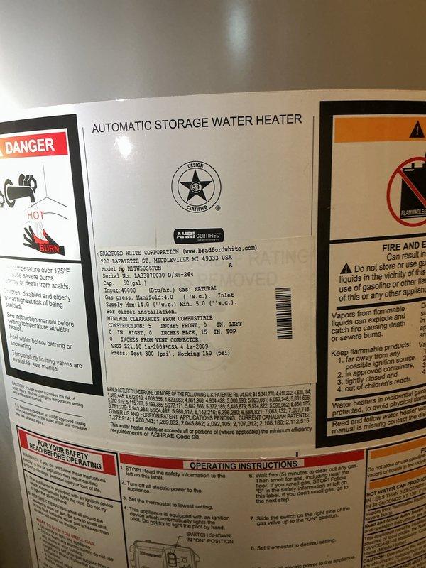 Provided free estimate for water heater and water softener replacement at residential property. Inspected existing 50-gallon Bradford White automatic storage natural gas water heater and associated plumbing system installed in basement utility area. Evaluated hydronic system configuration including white expansion tank, circulation pump with motor assembly, copper supply lines with brass fittings, PVC drainage piping, and pressure regulation components. Documented leaking water softener unit requiring replacement. Assessed current installation setup mounted against concrete block wall, noting copper and PVC pipe routing, electrical connections to pump assembly, and red-labeled valve positioning. Photographed equipment specifications including BTU rating, capacity, and clearance requirements for replacement planning purposes. Reviewed system functionality and provided comprehensive estimate for complete water heater and water softener replacement to address existing leak condition and u