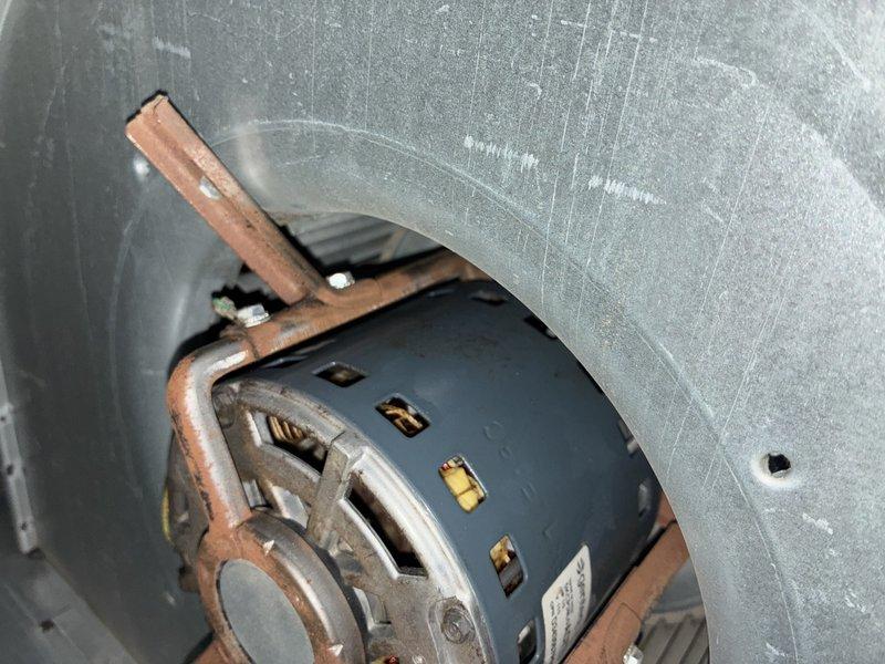 Responded to service call for water puddle in basement near 11-year-old furnace. Upon inspection, identified condensate drainage issue from air conditioning system. Inspected blower motor assembly and blower wheel, which showed normal dust accumulation consistent with system age. Cleared condensate line obstruction, verified proper drainage flow, and confirmed blower motor operation. System tested and returned to normal operation with no further water leakage observed.