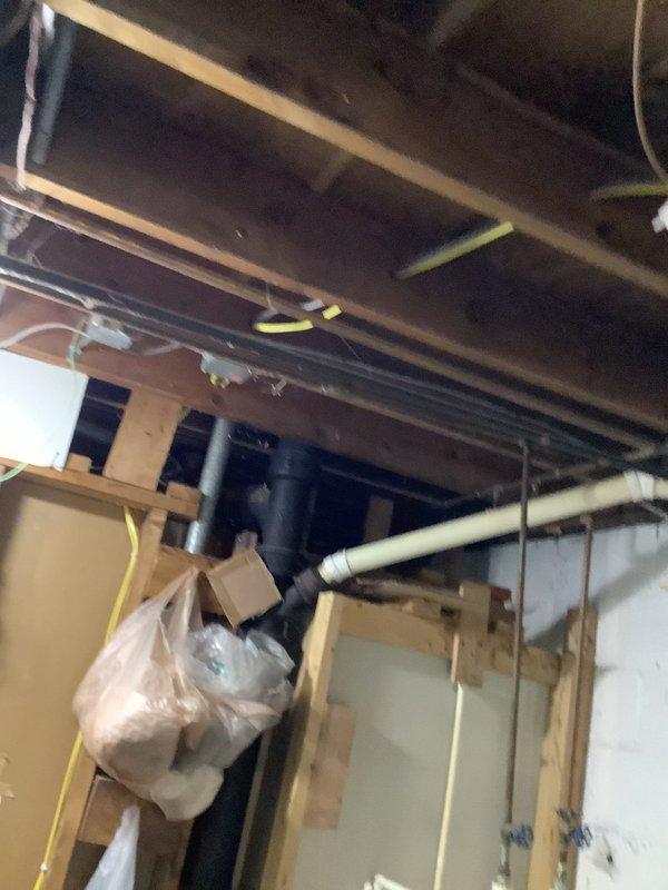 Installed customer-supplied kitchen sink with multiple water supply connections and customer-supplied garbage disposal unit. Reworked existing drain system to accommodate new fixture configuration. Performed electrical work to convert hardwired disposal connection to standard outlet configuration for both disposal and sink accessories. All plumbing connections tested and verified leak-free, disposal operational, and electrical outlet properly grounded and functioning.