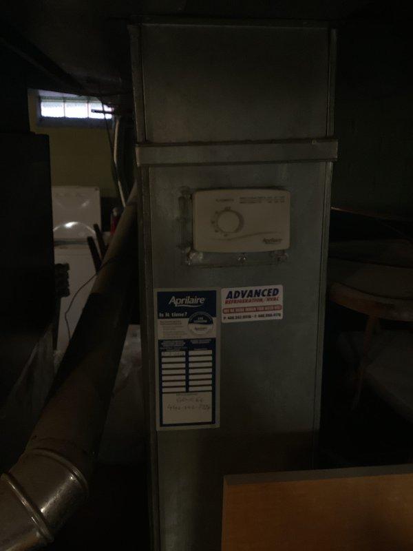 Conducted on-site assessment for complete furnace and air conditioning system replacement. Evaluated existing heating equipment in basement utility area, documenting current Aprilaire-equipped furnace configuration and associated ductwork connections. Observed moisture-related concrete floor deterioration and efflorescence near equipment location, noting potential environmental factors for new system installation planning. Provided comprehensive replacement estimate for both heating and cooling components scheduled for installation.