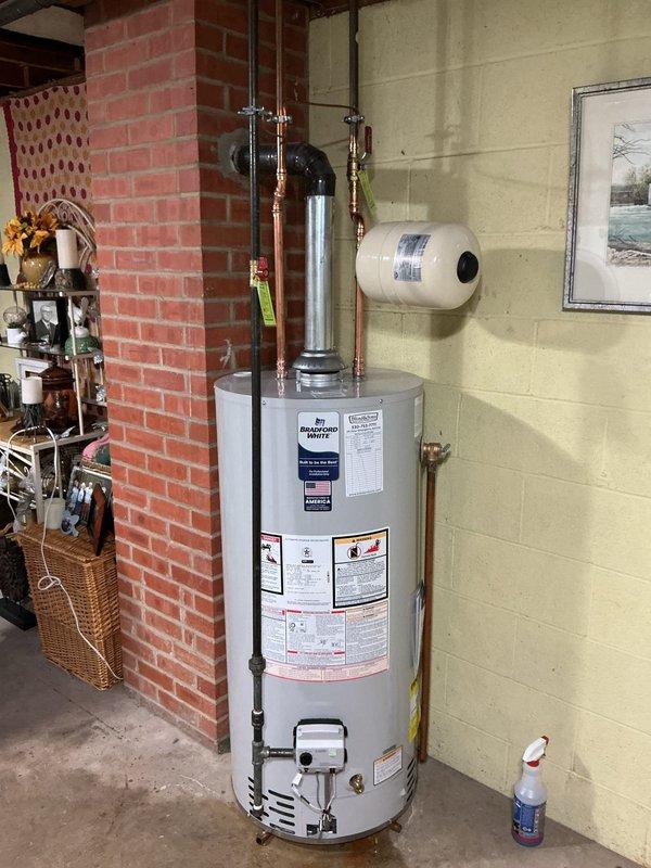 Installed a new 40-gallon short Bradford White water heater with 6-year manufacturer warranty. Installation included a new ball valve, gas shut-off valve, and thermal expansion tank. All components were professionally connected with copper piping, brass fittings, and proper support brackets. The unit was properly vented with galvanized flue piping and secured according to code requirements. System was tested and verified operational upon completion.