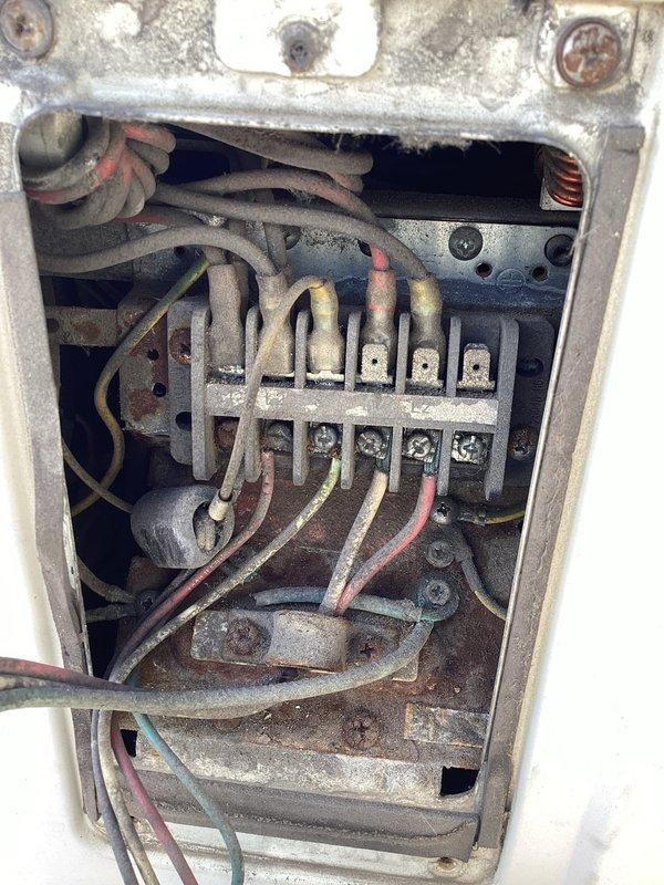 Responded to service call for commercial mini split system displaying F5 error code. Upon inspection, discovered severely corroded electrical connections and deteriorated wiring within the junction box, along with significant rust on associated mechanical components including filter housing and pipe connections. Diagnosed F5 code as communication failure between indoor and outdoor units caused by compromised electrical connections due to advanced corrosion and age-related wire insulation breakdown.