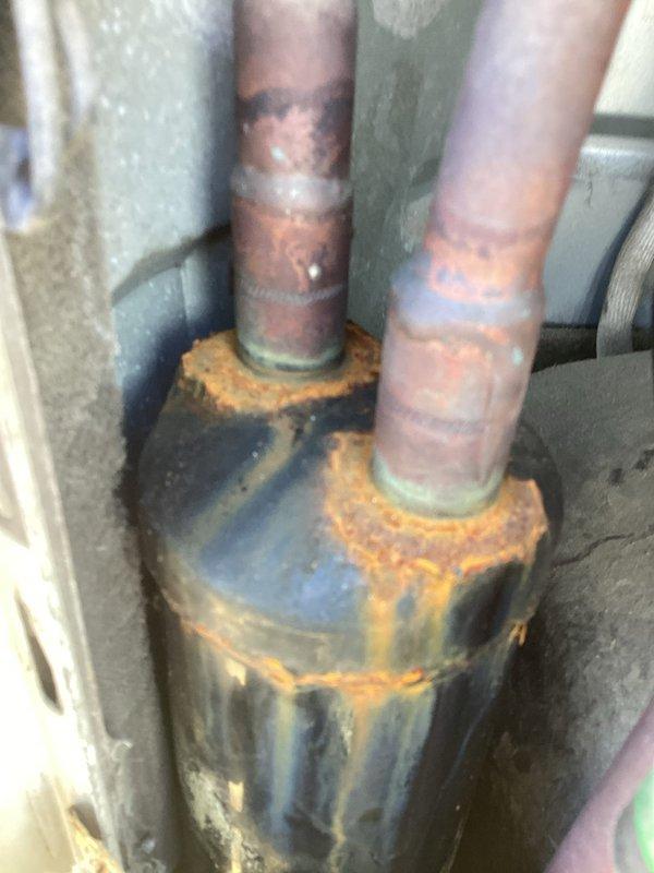 Responded to service call for commercial mini split system displaying F5 error code. Upon inspection, discovered severely corroded electrical connections and deteriorated wiring within the junction box, along with significant rust on associated mechanical components including filter housing and pipe connections. Diagnosed F5 code as communication failure between indoor and outdoor units caused by compromised electrical connections due to advanced corrosion and age-related wire insulation breakdown.