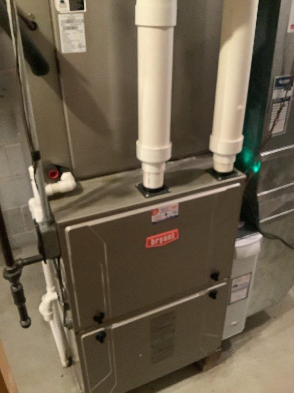Completed full HVAC system installation including a 96% AFUE Bryant furnace and matching air conditioning unit. Installed furnace in basement utility area with proper PVC venting system for intake and exhaust, connected all necessary gas lines, electrical connections, and drainage components. Mounted outdoor condensing unit on concrete pad with appropriate clearances, ran refrigerant lines and electrical conduit to exterior disconnect, and completed all connections to meter base. System tested and verified operational at manufacturer specifications.