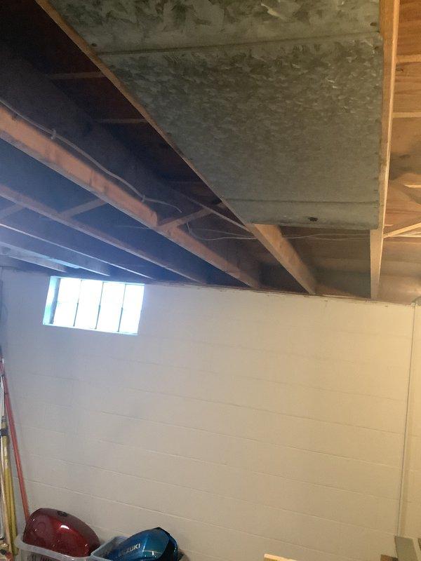Conducted comprehensive on-site evaluation for furnace and air conditioning system replacement. Assessed existing HVAC infrastructure in basement utility area, including ductwork configuration, structural requirements, and current system placement. Documented existing galvanized ductwork penetrations through foundation walls, evaluated ceiling joist clearances for new equipment installation, and photographed current conditions to develop accurate replacement specifications and installation plan.