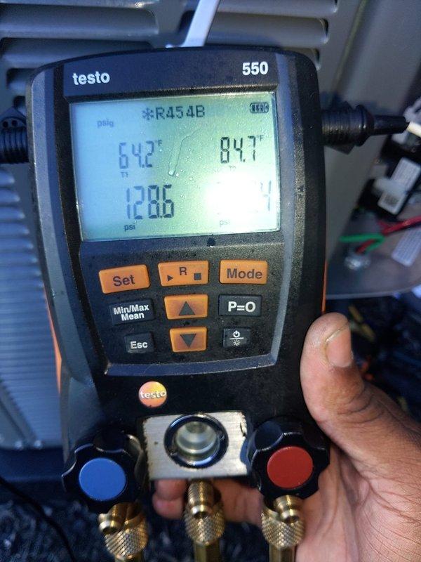 Completed installation of outdoor A/C unit and evaporator coil system utilizing R454B refrigerant. Installed brass manifold valve assembly with copper line connections, mounted unit on vibration-dampening pad against exterior brick wall, and verified system pressures and temperatures within manufacturer specifications using digital manifold gauges.