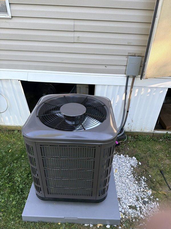 Completed installation of new air conditioning condenser unit and evaporator coil system. Mounted condenser on concrete pad adjacent to home exterior with proper clearances maintained. Installed new 30-amp fuses in disconnect box to protect electrical circuit. Verified unit operation with fan running properly and all protective grilles secured. System positioned on level pad with adequate drainage and airflow access.