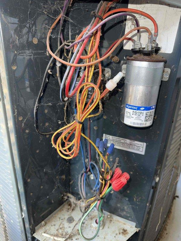 Responded to no cooling call where furnace was running but air conditioning system was not operating. Upon inspection, found failed capacitor with severe corrosion, cracked casing, and deteriorated terminals. Replaced defective capacitor with new unit, verified all electrical connections, and tested system operation. Air conditioning system restored to proper cooling function.