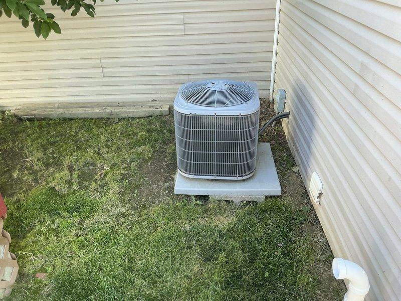 Completed HVAC system replacement for no cooling condition. Installed new gray furnace unit with evaporator coil in basement utility area against cinderblock wall, with proper PVC condensate drainage, gas lines, and metallic flexible ductwork connections. Installed new outdoor condenser unit on concrete pad in backyard with copper refrigerant lines and electrical conduit properly routed to exterior wall, system operational upon completion.