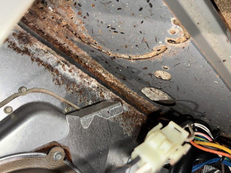Responded to service call for non-operational air conditioning system. Upon arrival, performed comprehensive system inspection of outdoor condensing unit. Found extensive corrosion on refrigerant lines and mounting components, indicating prolonged exposure to environmental elements. Discovered severely clogged evaporator coil with heavy accumulation of dust, dirt, and debris restricting airflow through the system. 

Documented equipment condition through photographic evidence showing deteriorated metal surfaces, corroded refrigerant lines, and significant buildup within air handler cabinet. The excessive debris accumulation on evaporator coil was identified as primary cause of system failure, preventing proper heat exchange and airflow. Electrical connections and wiring harness inspected and found to be in acceptable working condition despite age of surrounding components.

Recommended thorough evaporator coil cleaning, evaluation of refrigerant line integrity due to corrosion concerns