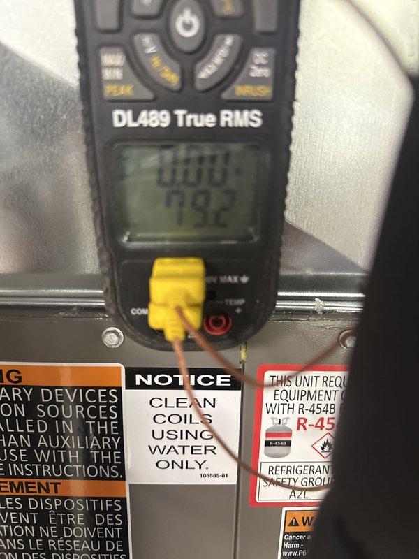 Completed installation of 80% efficiency furnace and air conditioning system. Installed control board with integrated circuit components, terminal connections, and LED display for system diagnostics. Verified proper electrical connections and tested system operation using digital multimeter, confirming voltage readings and system functionality. Unit utilizes R-454B refrigerant per manufacturer specifications and equipment labeling.