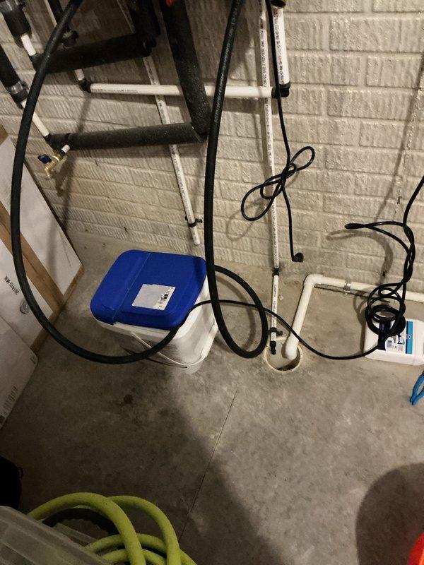 Performed tankless water heater descaling service using chemical flush procedure. Connected circulation pump and descaling solution container to unit's isolation valves, ran cleaning solution through heat exchanger for proper deliming treatment to remove mineral buildup and restore optimal performance.
