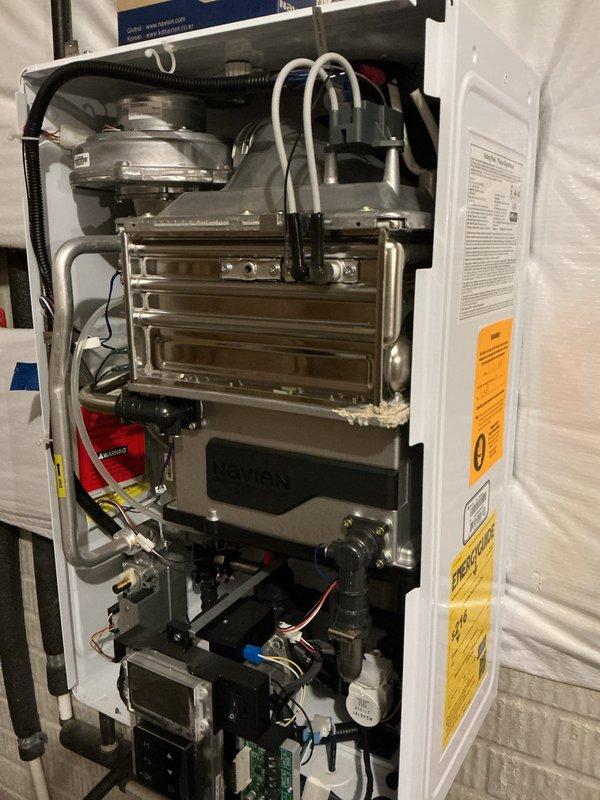 Performed tankless water heater descaling service using chemical flush procedure. Connected circulation pump and descaling solution container to unit's isolation valves, ran cleaning solution through heat exchanger for proper deliming treatment to remove mineral buildup and restore optimal performance.