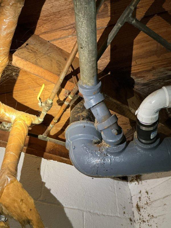 Responded to whole-home water leak originating in basement bathroom area with dirty water present. Upon inspection, identified compromised drain piping beneath bathroom sink and in crawlspace above affected area. Inspected under-sink plumbing configuration including PVC trap assembly and drainage connections for signs of failure or blockage. Accessed crawlspace to examine gray PVC waste line routing and connections near bathroom fixtures, noting soil accumulation and potential seal degradation at pipe penetrations. Documented plumbing infrastructure conditions including pipe joints, couplings, and structural penetration points. Communicated findings and coordinated service completion with homeowner.