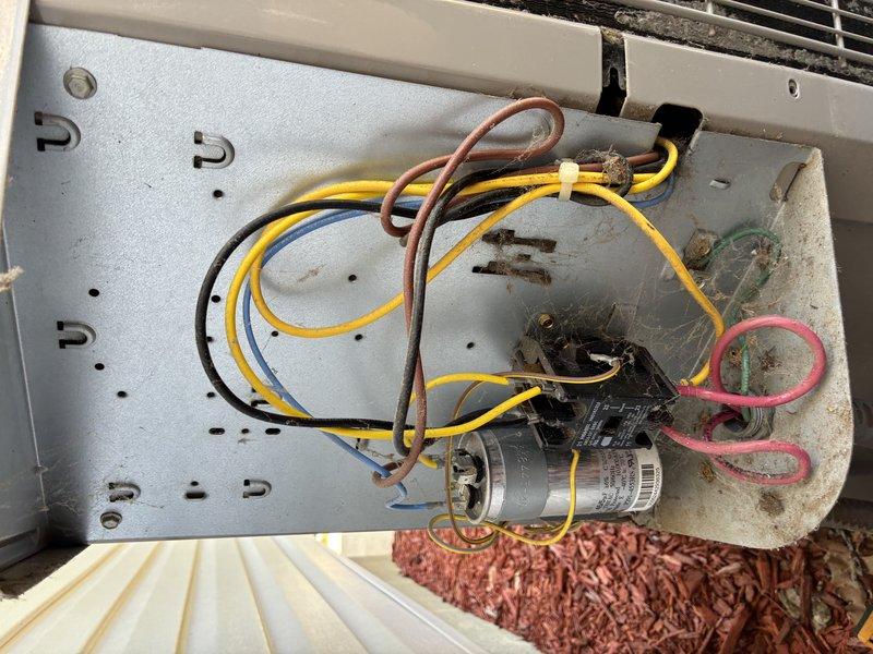 Completed scheduled BS-MVP cooling maintenance visit on Bryant brand outdoor condensing unit. Performed comprehensive system inspection, documenting unit condition and electrical components including capacitor assembly with proper wire connections and secure mounting. Unit found operating properly with clean exterior surfaces, functional fan assembly, and all electrical connections intact on stable concrete pad foundation.