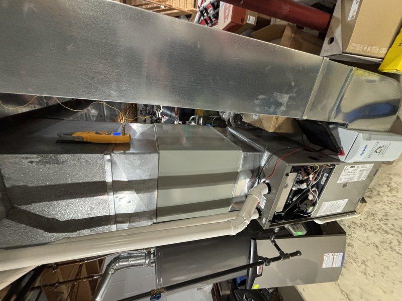 Completed scheduled commercial HVAC maintenance on air handler unit experiencing recurring cooling issues. Performed comprehensive inspection of approximately 5-year-old system, accessing internal components to evaluate evaporator coil condition, electrical connections, and control board functionality. Observed dust accumulation on heat exchange fins and documented moisture staining on exterior insulation, indicating potential condensate drainage concerns. Verified refrigeration line integrity and system operation to address reported cooling performance problems.