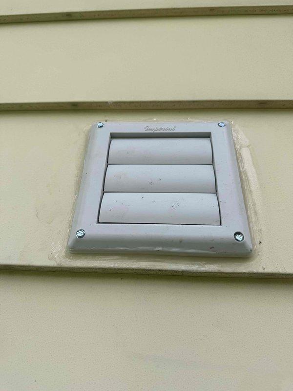 Installed customer-supplied bathroom exhaust fan system, including interior ceiling-mounted light fixture with bronze trim ring and white diffuser, and exterior wall vent with louvered cover on vinyl siding. All components were properly wired, secured, and sealed to ensure proper ventilation and weather protection.