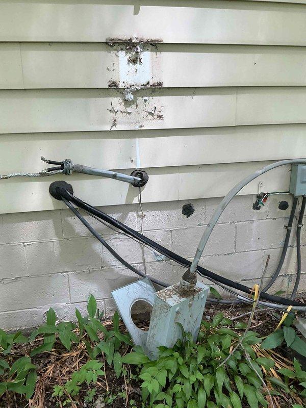 Responded to emergency storm damage call where tree limb severed overhead service cable, detaching electric meter and main service entrance conductors from residence. Coordinated with utility company to ensure safe disconnection at transformer. Removed damaged weatherhead, service mast, and meter base from exterior wall. Installed new meter base, conduit, and service entrance cable, securing all components to building structure per NEC requirements. Verified proper grounding and bonding connections at main electrical panel. Conducted final inspection of all circuit breakers and interior panel wiring to ensure no secondary damage occurred during power loss. Restored full electrical service to 1968 residence after utility company reconnected at meter base.