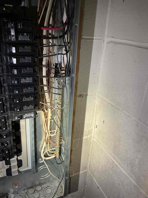 Responded to emergency storm damage call where tree limb severed overhead service cable, detaching electric meter and main service entrance conductors from residence. Coordinated with utility company to ensure safe disconnection at transformer. Removed damaged weatherhead, service mast, and meter base from exterior wall. Installed new meter base, conduit, and service entrance cable, securing all components to building structure per NEC requirements. Verified proper grounding and bonding connections at main electrical panel. Conducted final inspection of all circuit breakers and interior panel wiring to ensure no secondary damage occurred during power loss. Restored full electrical service to 1968 residence after utility company reconnected at meter base.