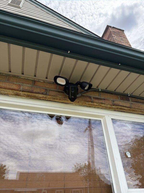Installed new dedicated electrical circuit for ring light above exterior window. Ran conduit and wiring from existing outdoor outlet, routing above window opening to new fixture location. Completed exterior electrical work with proper weatherproof connections and secure conduit mounting to brick facade.