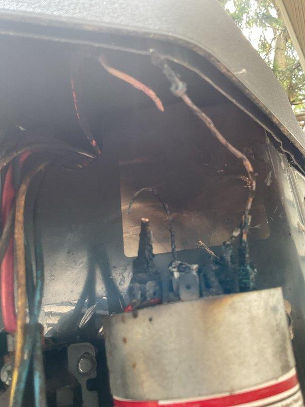 Responded to no cool condition on outdoor air conditioning unit. Upon inspection, found failed run capacitor with severe burn damage at terminals, charred wiring, and corroded electrical connections. Replaced damaged capacitor, repaired burned wiring harness, cleaned and secured all electrical connections within contactor panel. Verified proper voltage and amperage readings, tested system operation through complete cooling cycle. Unit restored to normal operation with proper cooling performance confirmed.