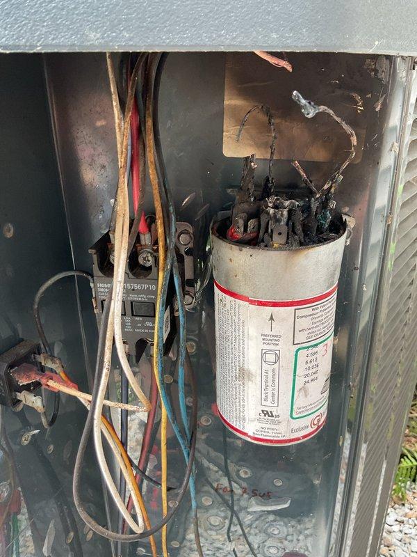 Responded to no cool condition on outdoor air conditioning unit. Upon inspection, found failed run capacitor with severe burn damage at terminals, charred wiring, and corroded electrical connections. Replaced damaged capacitor, repaired burned wiring harness, cleaned and secured all electrical connections within contactor panel. Verified proper voltage and amperage readings, tested system operation through complete cooling cycle. Unit restored to normal operation with proper cooling performance confirmed.