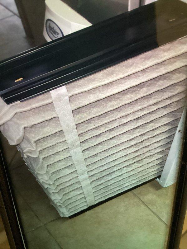 Completed MVP cooling maintenance visit on residential HVAC system. Inspected and documented air filter condition, noting dust accumulation on pleated media, and examined evaporator coil which displayed vertical staining pattern indicating moisture tracking and potential dirt buildup on fins. System operational at time of service.