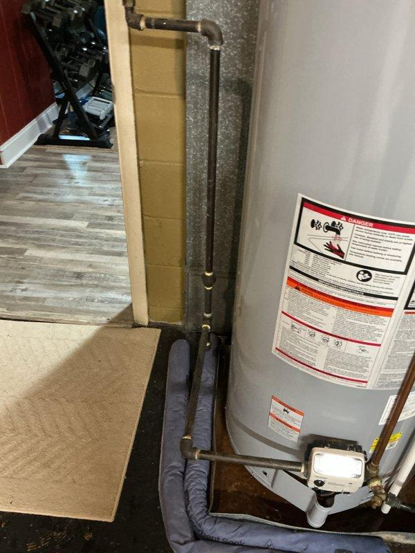 Conducted on-site assessment of 9-year-old 50-gallon residential water heater with 50,000 BTU input capacity requiring immediate replacement. Evaluated existing installation including all plumbing connections, copper supply lines, blue foam pipe insulation, drain pan, and gas line configuration in utility area. Provided competitive estimate for same-day water heater replacement with customer availability confirmed between 9:00 AM and 5:00 PM.
