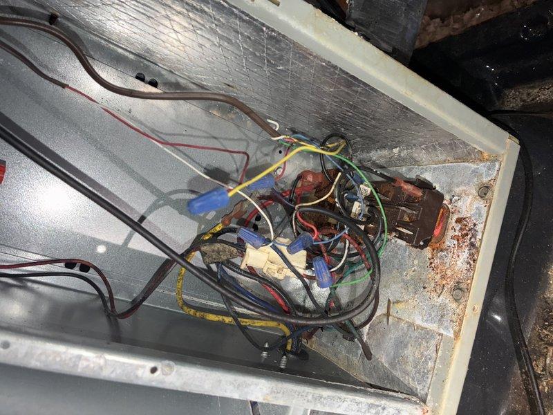 Responded to no-cooling call on 10-year-old air conditioning system. Upon inspection, discovered extensive rust and corrosion on electrical connections and mounting hardware within the unit, along with significant dirt accumulation on heat exchanger coils and wiring compartment. The corroded components and deteriorated connections were preventing proper system operation, causing the unit's failure to start.